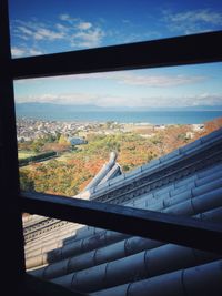 Aerial view of cityscape seen through window