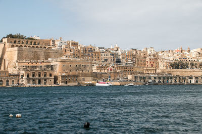 View of buildings by sea