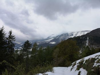 Scenic view of mountains against cloudy sky