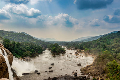 Scenic view of waterfall against sky