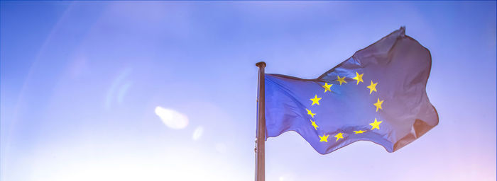 Low angle view of european union flag against blue sky