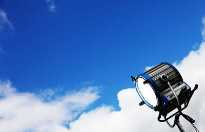 Low angle view of ferris wheel against blue sky