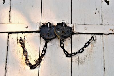 Close-up of old rusty padlocks on door