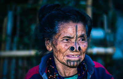 Senior woman looking away while standing outdoors