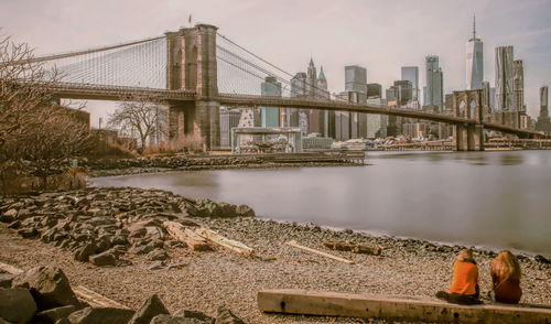 Bridge over river with buildings in background