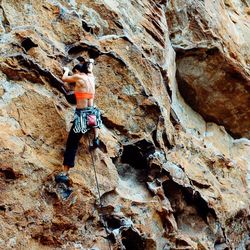 Full length of man climbing rocks