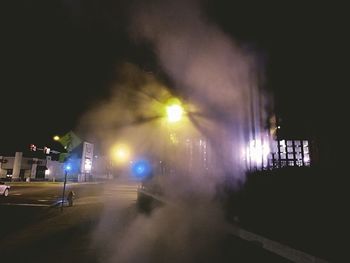 Illuminated city against sky at night