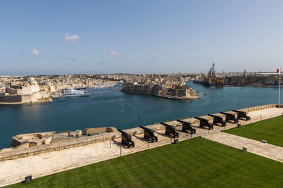 High angle view of boats in sea against buildings