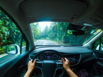 Man seen through car windshield