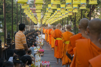 Rear view of people walking in temple