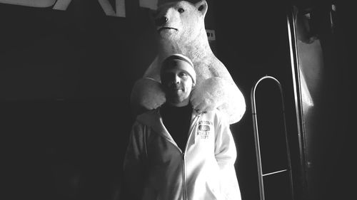 Portrait of man with polar bear taxidermy at museum