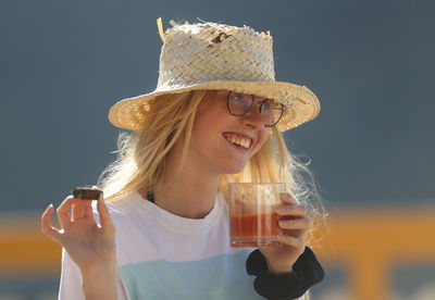 Midsection of a young woman drinking glass