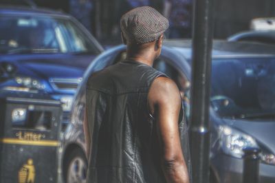 Rear view of man looking at bus