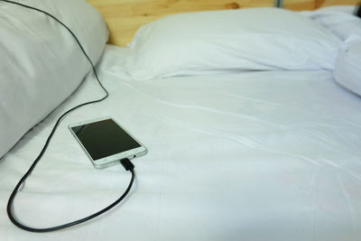 High angle view of laptop on bed at home