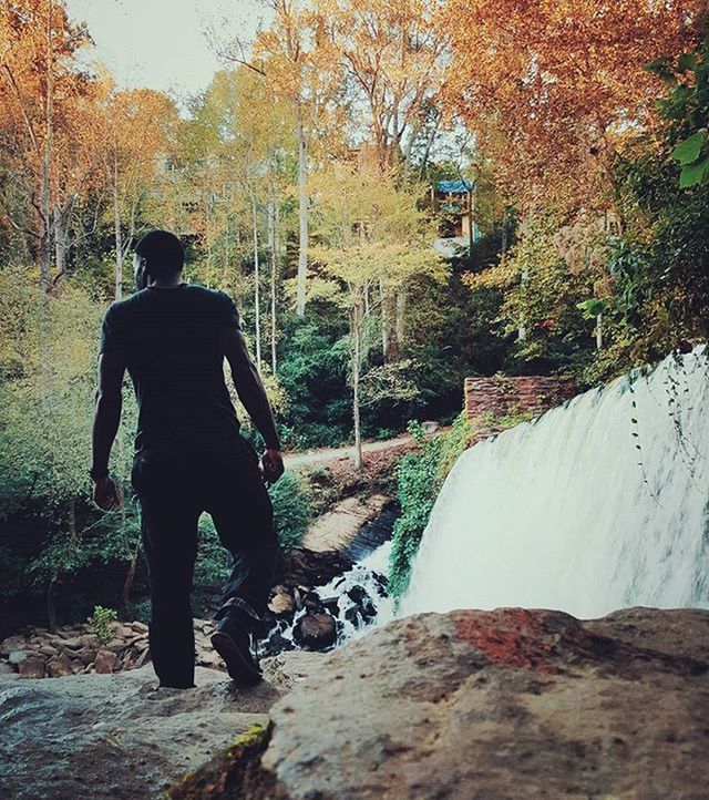 lifestyles, leisure activity, men, rear view, water, standing, full length, tree, casual clothing, rock - object, nature, person, river, forest, day, outdoors, tranquility