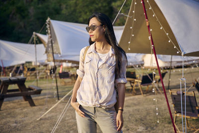 Woman looking away while standing outdoors