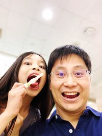 Close-up portrait of smiling boy eating