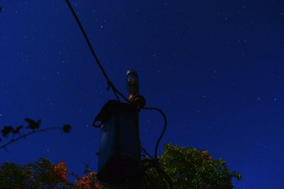 Low angle view of tree against sky at night