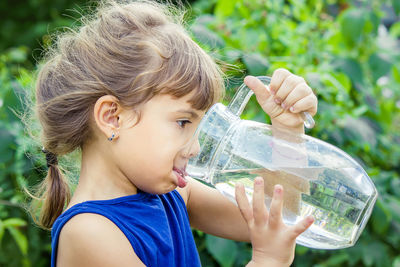 Close-up of young woman drinking water