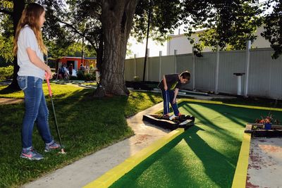 Full length of friends playing in park