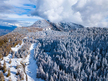 Scenic view of snow covered mountains against sky