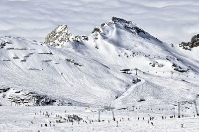 Low angle view of snow covered mountain against sky