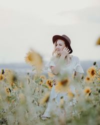 Full length of young woman on field against sky