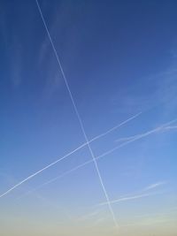 Low angle view of vapor trails in sky