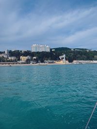 Scenic view of sea and buildings against sky