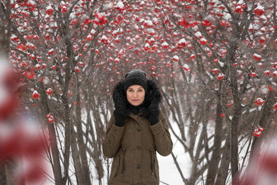 Portrait of young woman standing in forest