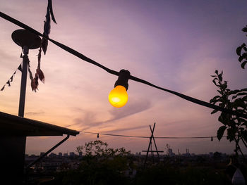 Low angle view of hanging light against sky