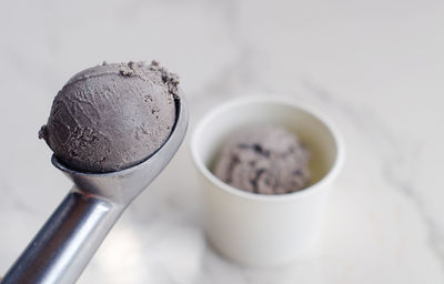 Close-up of ice cream on scoop over table