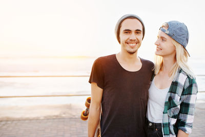 Portrait of smiling couple against sea