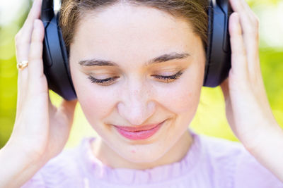 Close-up of young woman using mobile phone