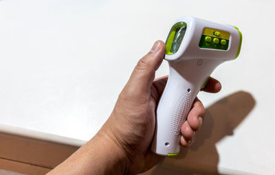 Close-up of hand holding camera