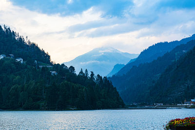 Scenic view of lake and mountains against sky