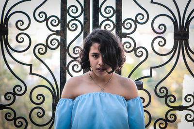 Portrait of a woman standing against the wall