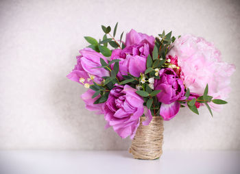 Close-up of pink flower vase on table