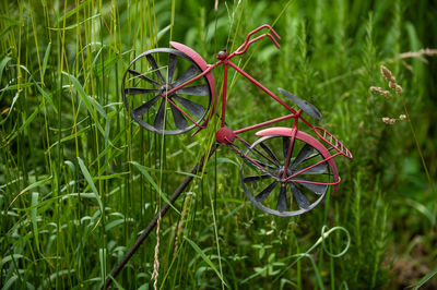 Close-up of bicycle wheel on field