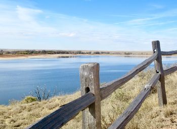 Wooden fence above reservoir in colorado