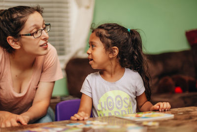 Mother assisting daughter in studies at home