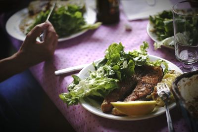 Close-up of person preparing food on plate