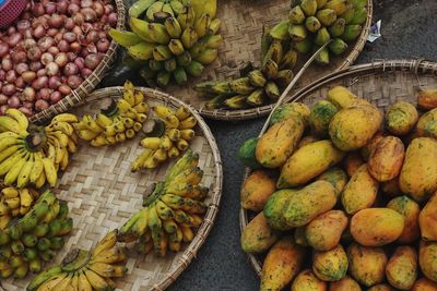 Street market. bananas, mangos and onions in bamboo plates