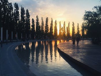 Scenic view of swimming pool against sky during sunset