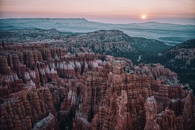 Panoramic view of bryce canyon landscape with sunrise in background