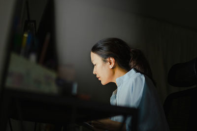 Side view of young woman looking away