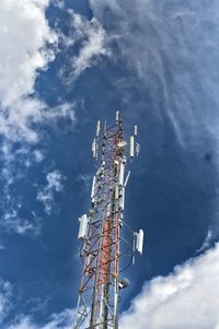 Low angle view of communications tower against sky