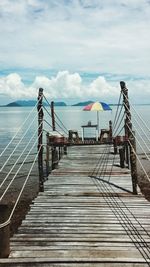 Wood paneled jetty against calm lake