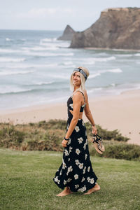 Full length portrait of woman standing on beach