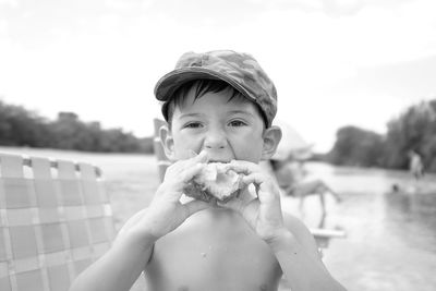 Portrait of shirtless man eating food